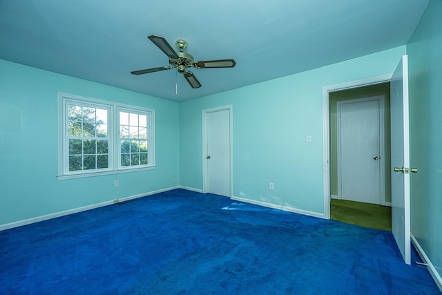 interior space with ceiling fan and dark colored carpet