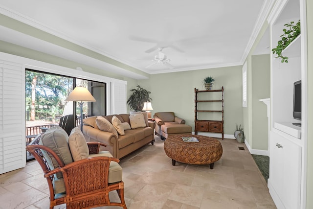 living area with stone tile flooring, ceiling fan, baseboards, and ornamental molding