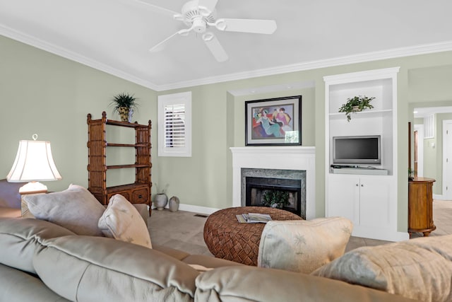 living room featuring ornamental molding, built in features, a high end fireplace, baseboards, and ceiling fan