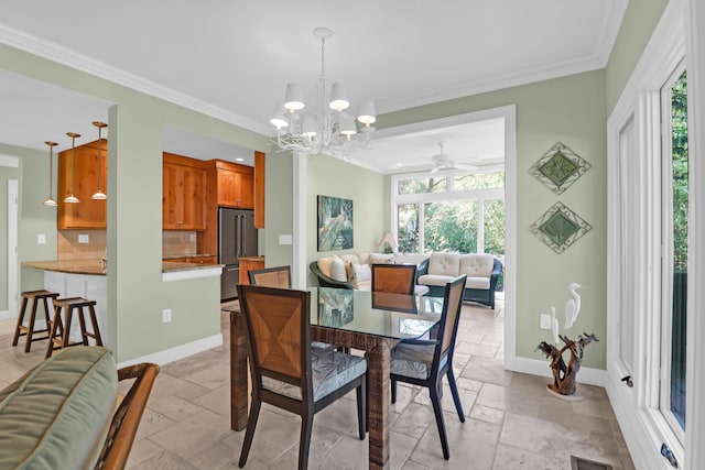 dining space featuring visible vents, crown molding, baseboards, a chandelier, and stone tile flooring