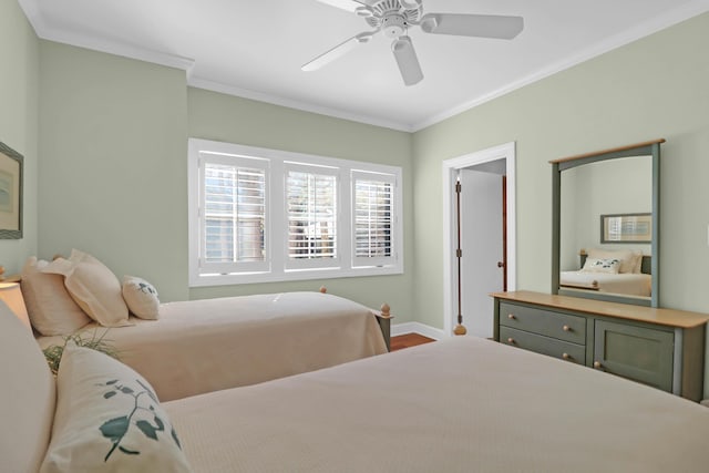 bedroom featuring a ceiling fan, baseboards, and ornamental molding