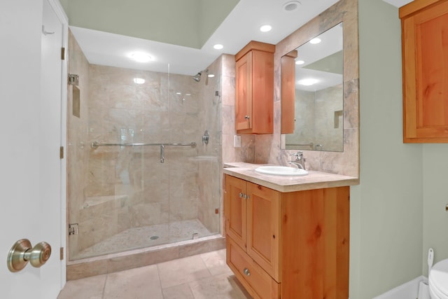 full bath featuring tile patterned flooring, vanity, a shower stall, and toilet