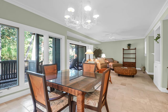 dining room with crown molding, ceiling fan with notable chandelier, and baseboards