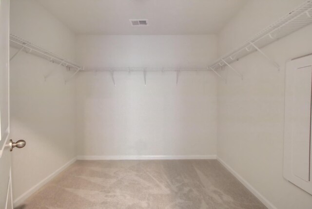 walk in closet with light carpet and visible vents