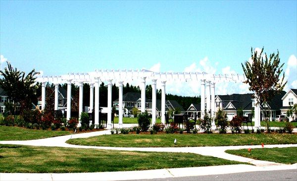 view of community with a residential view, a lawn, and a pergola