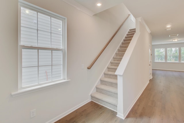 stairway with recessed lighting, wood finished floors, visible vents, and baseboards