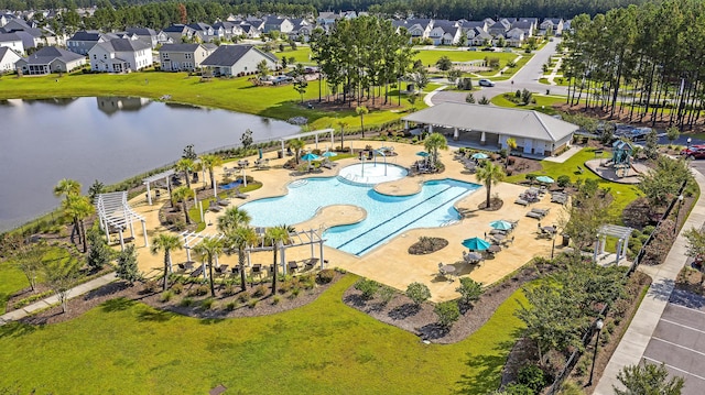 drone / aerial view with a water view and a residential view