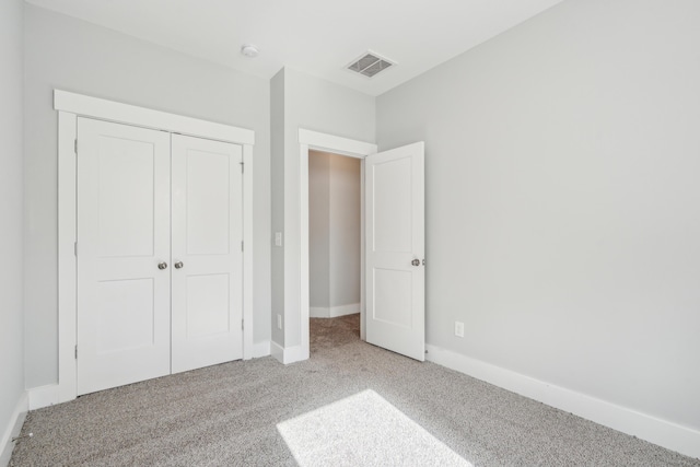 unfurnished bedroom with a closet and carpet