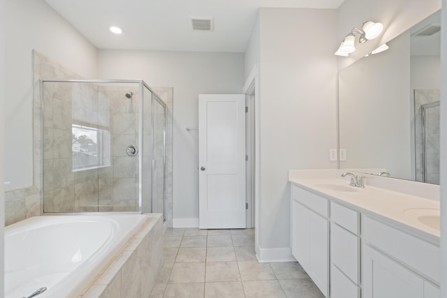 bathroom with tile patterned flooring, vanity, and shower with separate bathtub