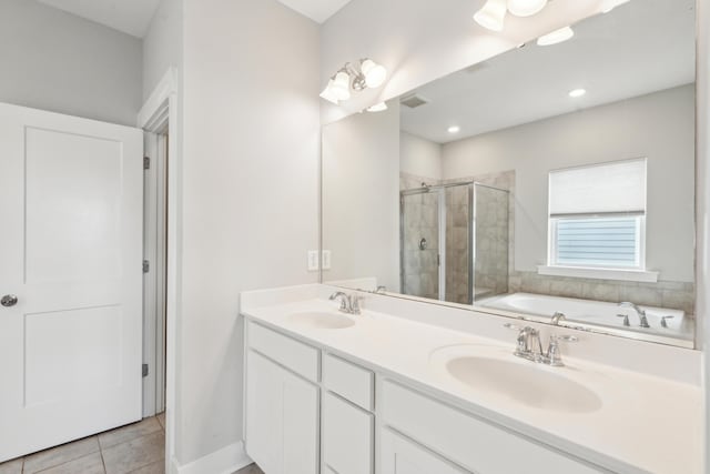 bathroom with tile patterned floors, separate shower and tub, and vanity