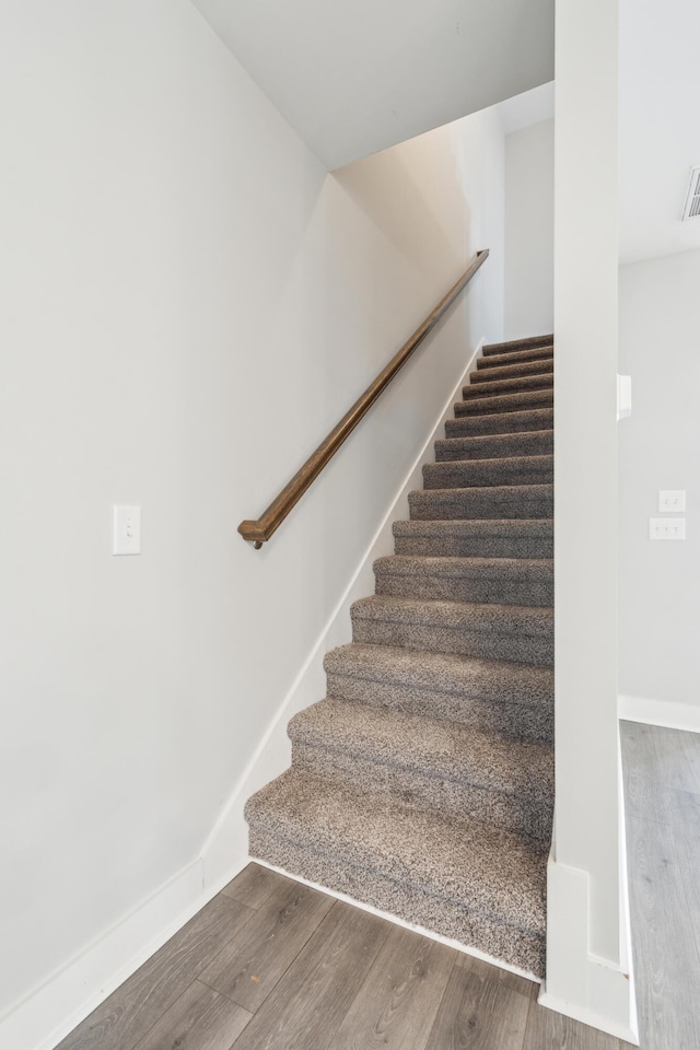 stairs with hardwood / wood-style flooring