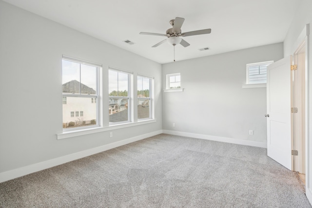 empty room with ceiling fan and carpet