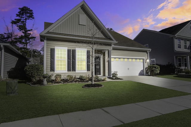 view of front of home featuring a garage and a lawn