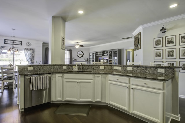 kitchen with dark hardwood / wood-style floors, decorative light fixtures, dishwasher, sink, and dark stone countertops