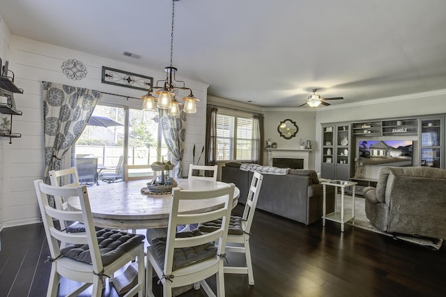 dining area featuring ceiling fan, ornamental molding, and dark hardwood / wood-style flooring