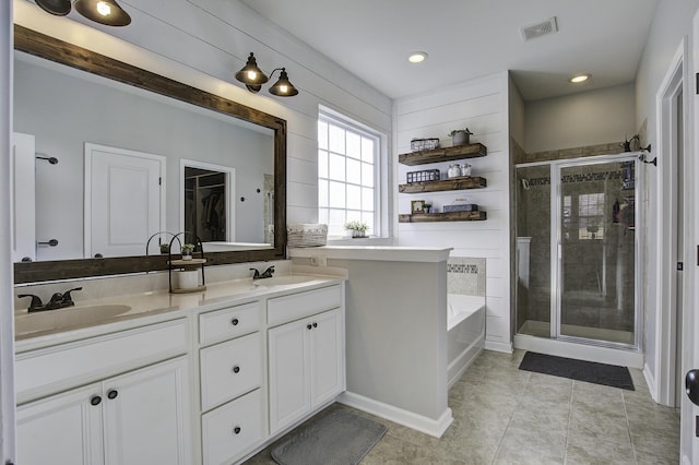 bathroom featuring tile patterned flooring, vanity, and plus walk in shower