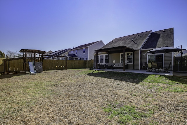 view of yard featuring outdoor lounge area, a patio, and a playground