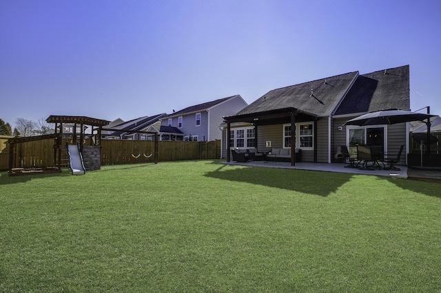 view of yard featuring an outdoor hangout area, a playground, and a patio area