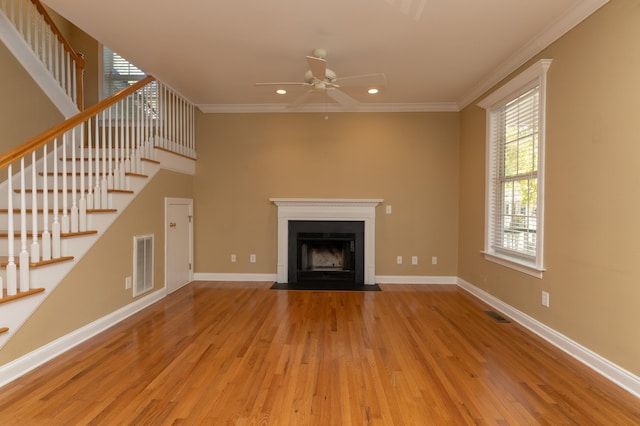 unfurnished living room featuring light hardwood / wood-style floors, ornamental molding, and ceiling fan