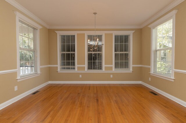 unfurnished dining area featuring crown molding, plenty of natural light, and light wood-type flooring