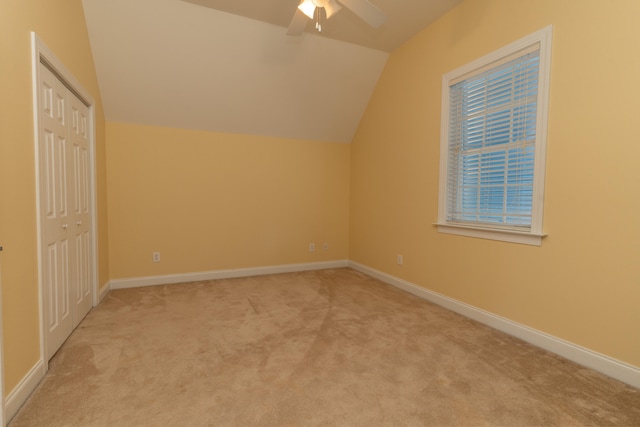 bonus room with lofted ceiling, light carpet, and ceiling fan