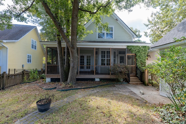 back of house featuring a sunroom