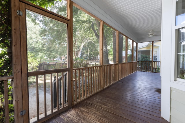 unfurnished sunroom featuring plenty of natural light and ceiling fan