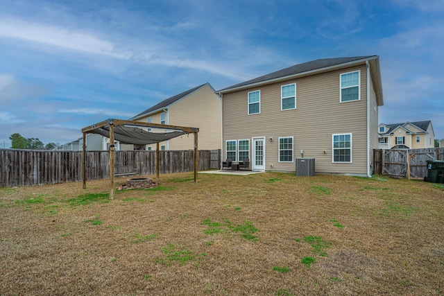 rear view of property featuring central AC, a yard, a pergola, and a patio