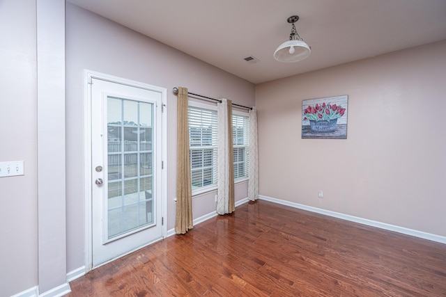 doorway to outside with dark wood-type flooring