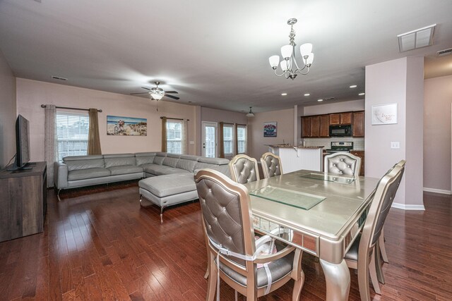 dining space with dark hardwood / wood-style floors and ceiling fan with notable chandelier