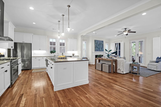 kitchen with white cabinets, premium appliances, and a kitchen island