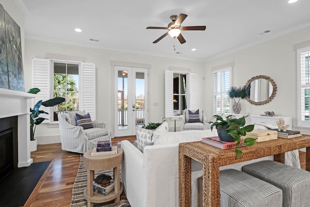 living room featuring crown molding, french doors, ceiling fan, and dark hardwood / wood-style floors