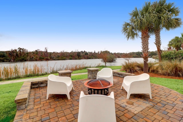 view of patio with a water view and an outdoor fire pit