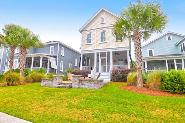 back of property with a sunroom and a lawn