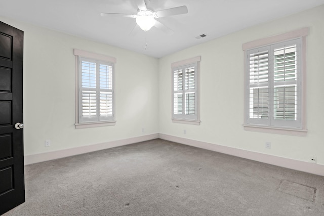 unfurnished room featuring ceiling fan, a healthy amount of sunlight, and light colored carpet