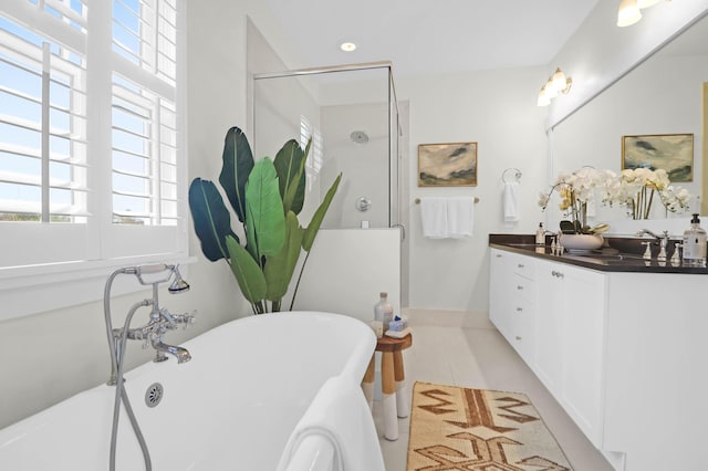 bathroom featuring tile patterned flooring, vanity, and independent shower and bath