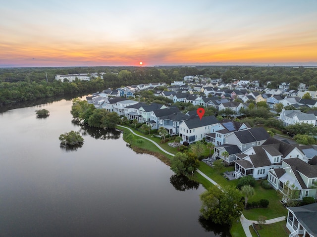 aerial view at dusk with a water view