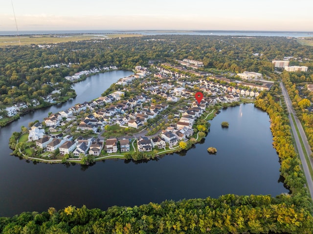 aerial view at dusk featuring a water view