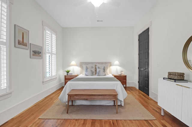 bedroom with wood-type flooring and ceiling fan