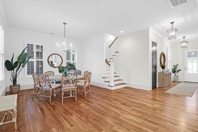 dining room featuring wood-type flooring and crown molding