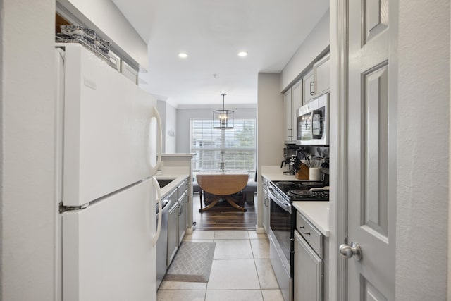 700 Daniel Ellis Dr Unit 10305, Charleston, SC 29412 - kitchen featuring appliances with stainless steel finishes, gray cabinetry, light countertops, recessed lighting, and light tile patterned floors