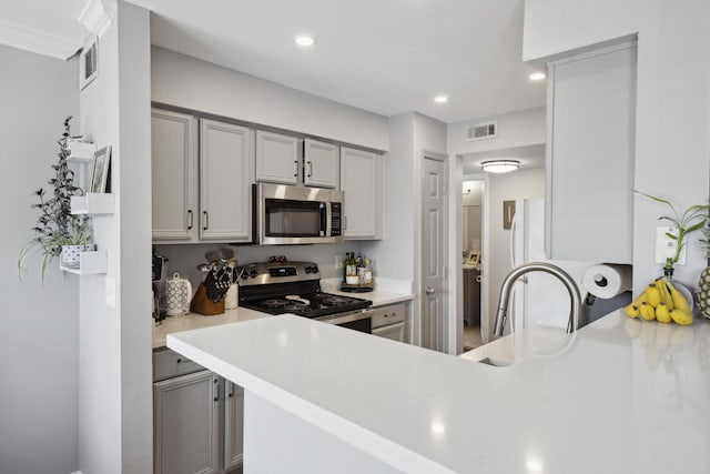 700 Daniel Ellis Dr Unit 10305, Charleston, SC 29412 - kitchen featuring appliances with stainless steel finishes, gray cabinetry, light countertops, a sink, and recessed lighting