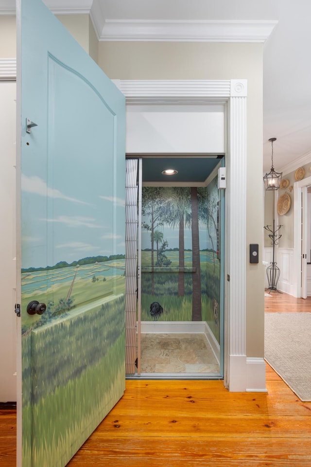 bathroom with ornamental molding, wood finished floors, and a chandelier