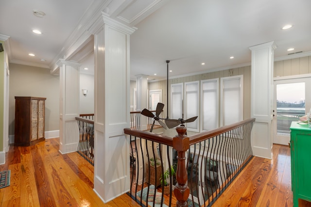corridor with an upstairs landing, ornate columns, ornamental molding, hardwood / wood-style floors, and recessed lighting