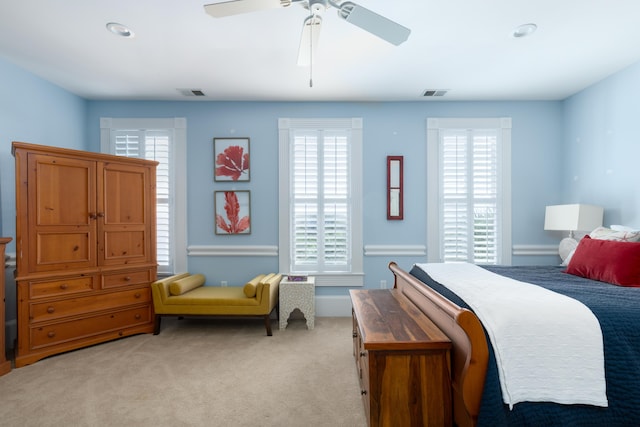 bedroom with multiple windows, light colored carpet, ceiling fan, and recessed lighting