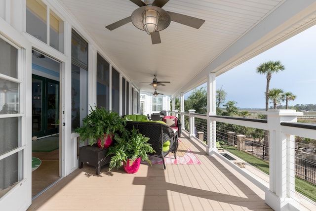 wooden terrace featuring a ceiling fan and covered porch