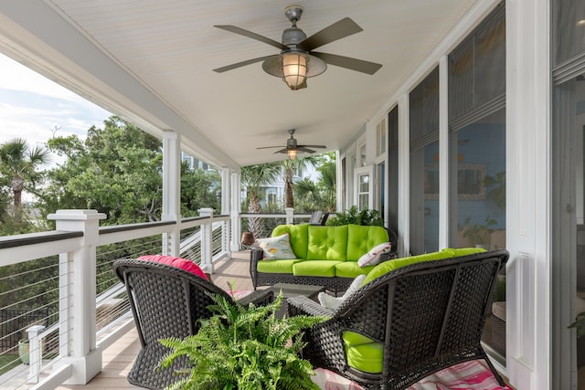 wooden deck featuring a ceiling fan and an outdoor living space