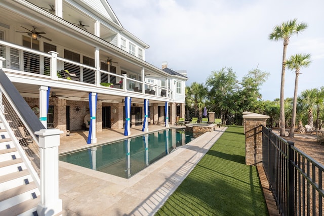 view of swimming pool with ceiling fan, a patio, and a pool with connected hot tub