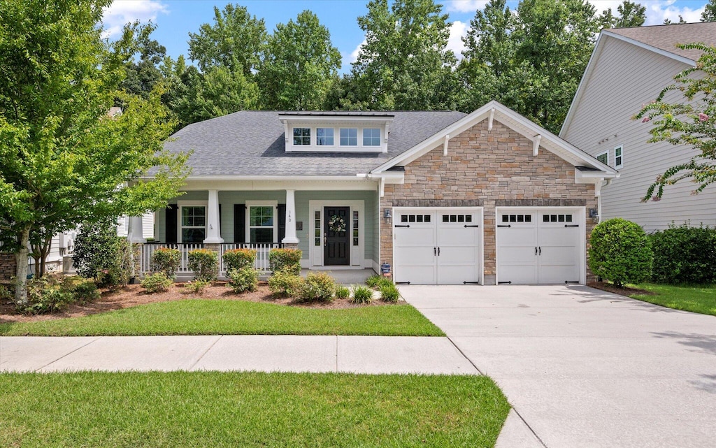 view of front facade featuring a garage and covered porch