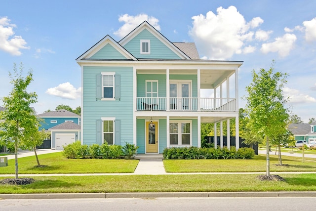 view of front of house with a front yard, a garage, a balcony, and covered porch